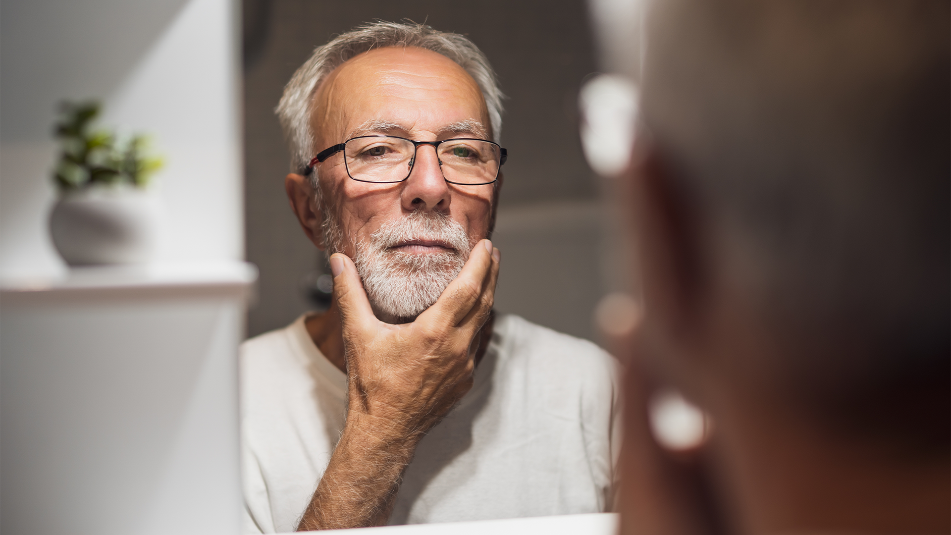 Foto di un uomo preoccupato perché percepisce i denti che si muovono